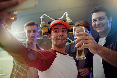 Buy stock photo Cropped shot of guys taking a selfie while drinking beer at a party