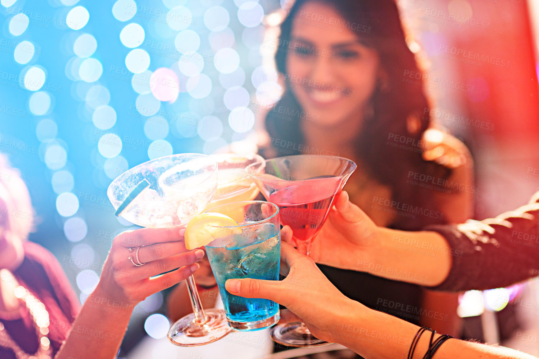 Buy stock photo Cropped shot of a group of women celebrating with cocktails at a party