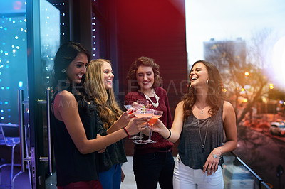 Buy stock photo Women, friends and group toast with cocktail at pub together for celebration, event or happy hour at night club. Cheers, party and girls with alcohol glass at bar for social gathering, drink or laugh