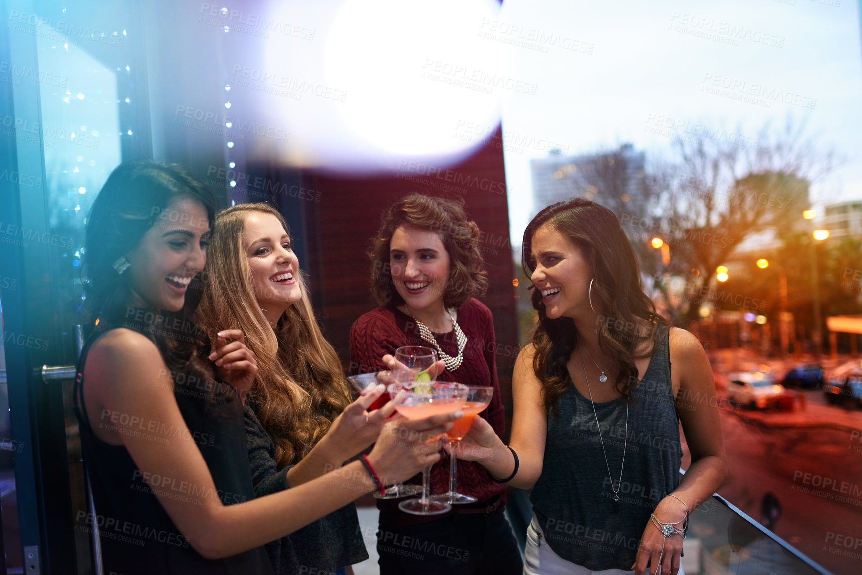 Buy stock photo Shot of a group of young women drinking cocktails at a party