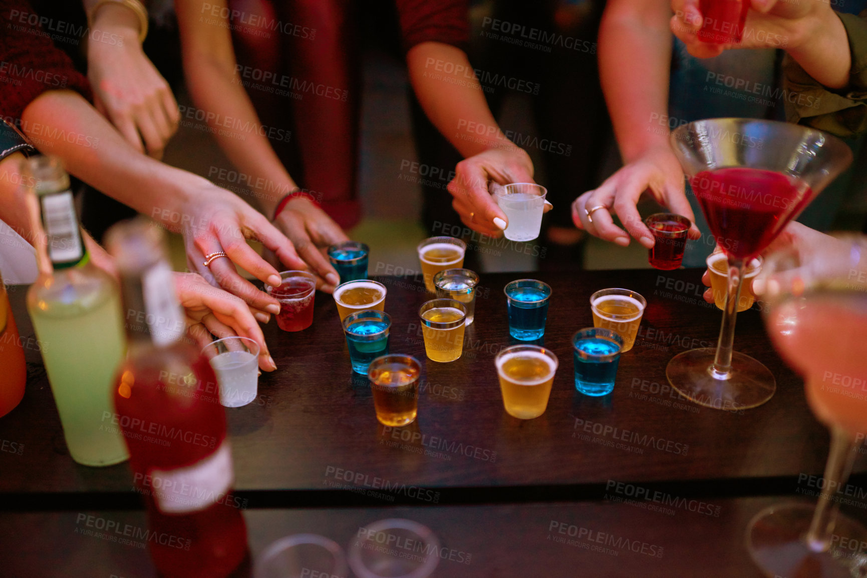 Buy stock photo Alcohol, friends and hands at party in pub for birthday, friendship and celebration in restaurant. Fun, colleagues and bonding over drinks in bistro or bar for entertainment, relaxing and happy hour