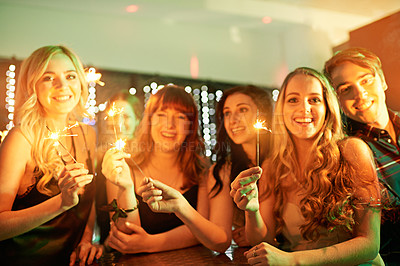 Buy stock photo Shot of a group of girlfriends having fun with sparklers on a night out