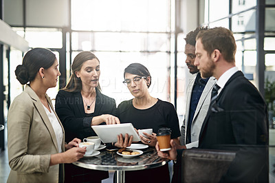 Buy stock photo Cropped shot of a group of businesspeople looking at a tablet in the office