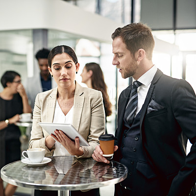 Buy stock photo Business people, tablet and coffee with collaboration for research, proposal or discussion at office. Businessman and woman with technology, drink or ideas for conversation on project at workplace