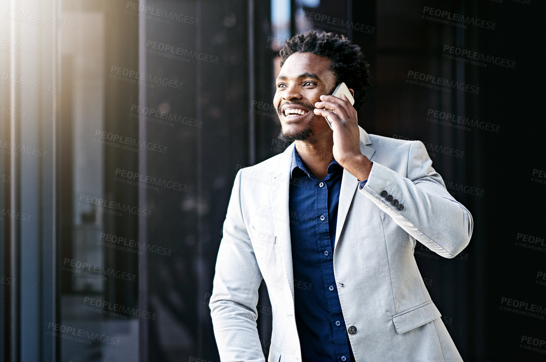 Buy stock photo Cropped shot of a young businessman using his cellphone on the office balcony