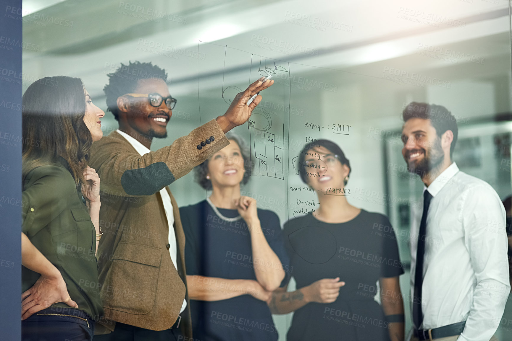 Buy stock photo Cropped shot of a group of businesspeople brainstorming with notes on a glass wall in an office