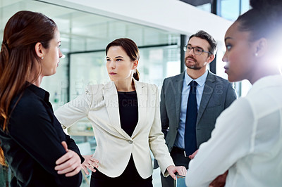 Buy stock photo Cropped shot of a group of businesspeople having a serious discussion in the office