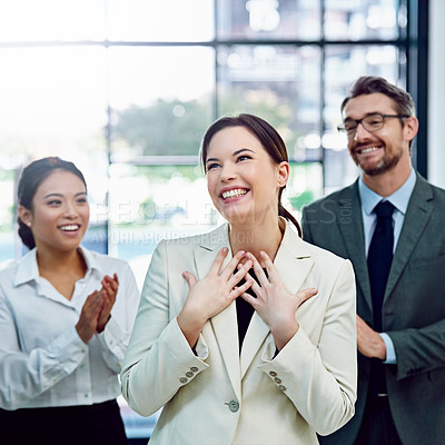 Buy stock photo Shot of a succesful businesswoman being applauded by her colleagues in the office