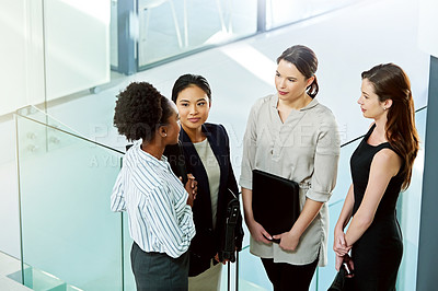 Buy stock photo Shot of businesswoman standing together while discussing business in the office
