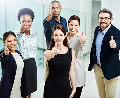 Buy stock photo High angle portrait of a group of businesspeople standing together and showing a thumbs up in the office