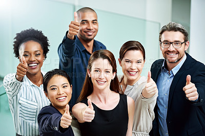 Buy stock photo High angle portrait of a group of businesspeople standing together and showing a thumbs up in the office