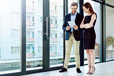 Buy stock photo Full length shot of two businesspeople talking in the office