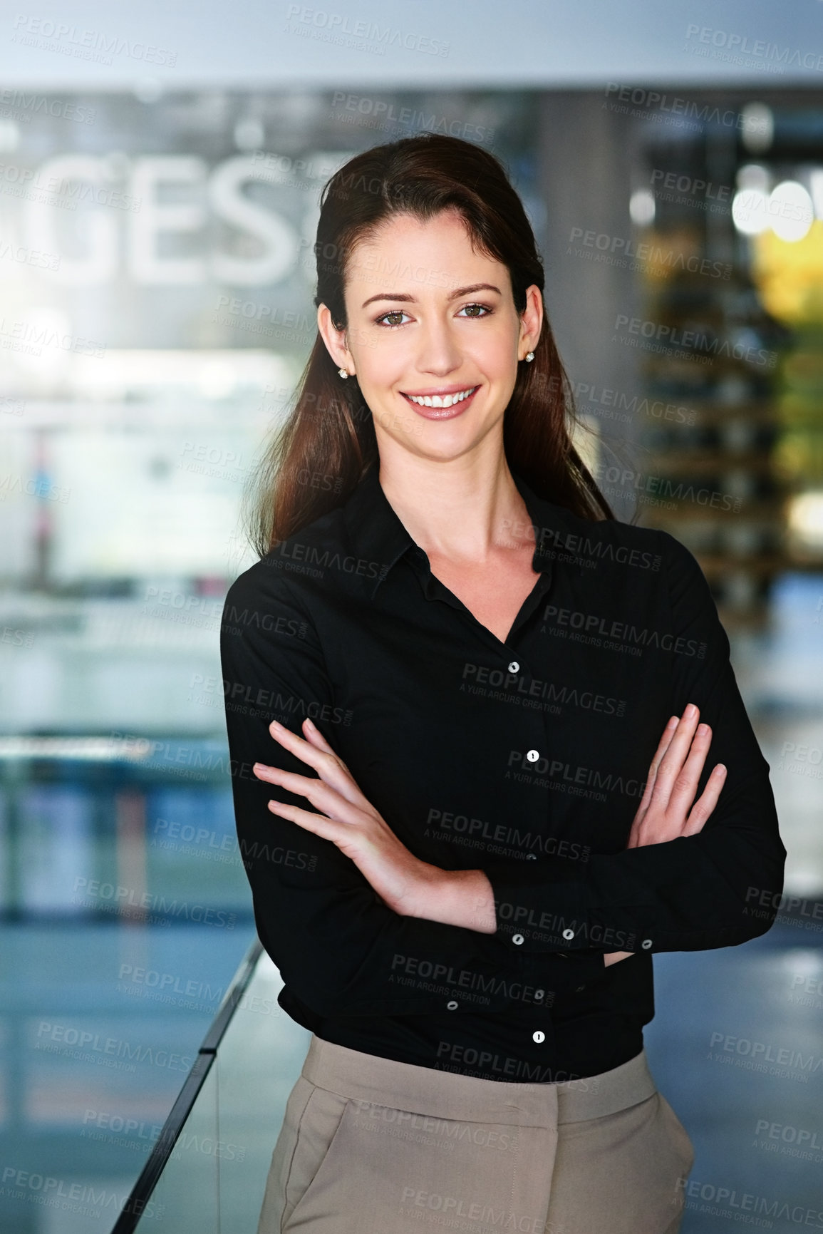 Buy stock photo Portrait of a young businesswoman standing with her arms folded in the office