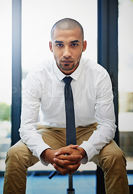 Buy stock photo Portrait of a determined looking businessman sitting in the office