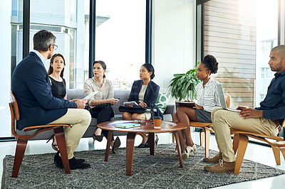 Buy stock photo Shot of a group of work colleagues talking together in a meeting in an office