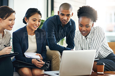 Buy stock photo Shot of a group of businesspeople talking together over a laptop during a meeting