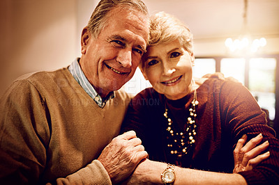 Buy stock photo Cropped portrait of an elderly couple embracing in their home