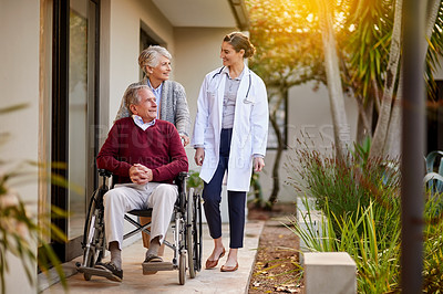 Buy stock photo Shot of a senior couple and a nurse outside a nursing home