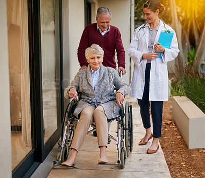 Buy stock photo Shot of a senior couple and a nurse outside a nursing home