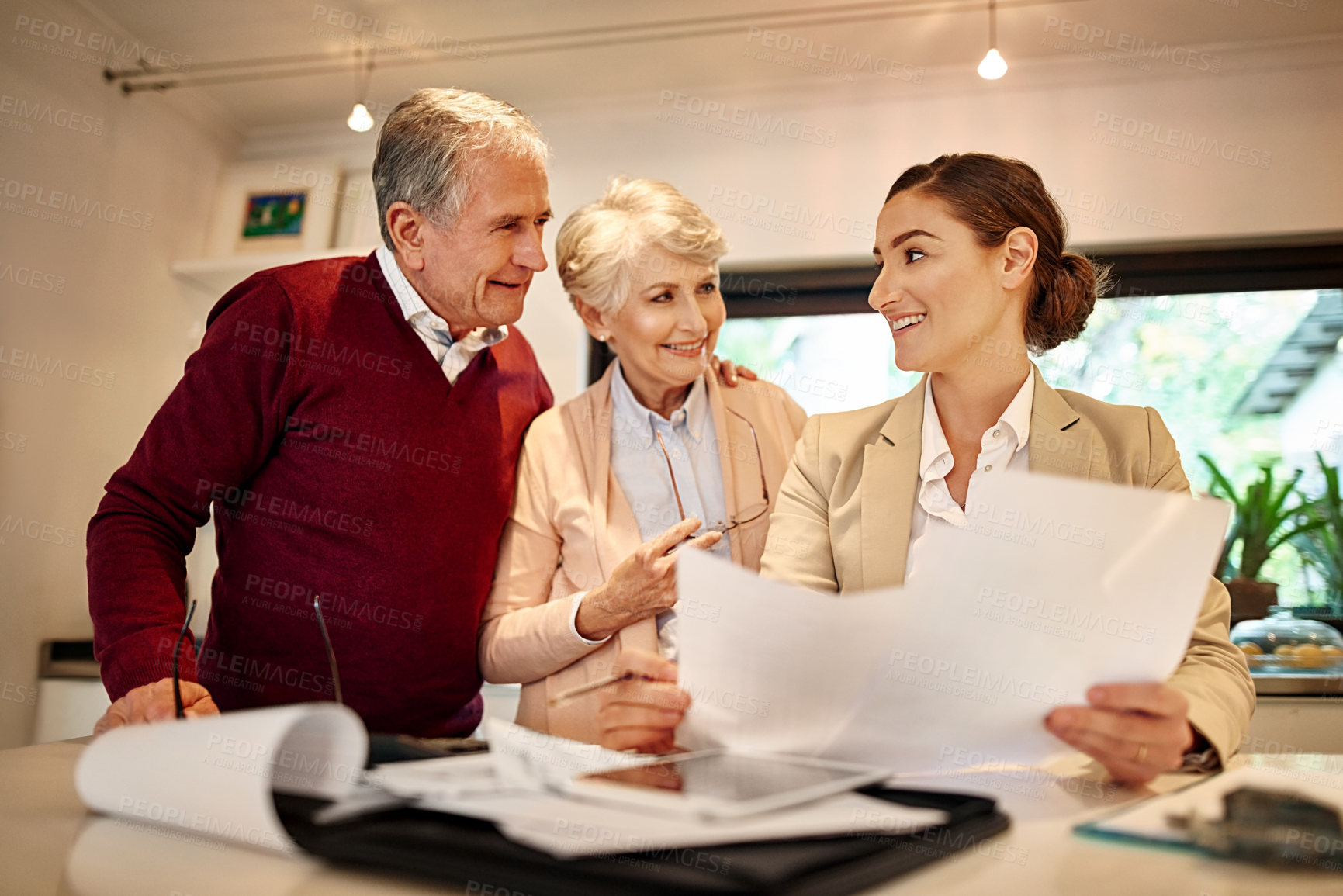 Buy stock photo Senior couple, financial advisor and paperwork in discussion for budget or retirement plan at home. Happy elderly man and woman with consultant or lawyer and documents for investment planning or loan