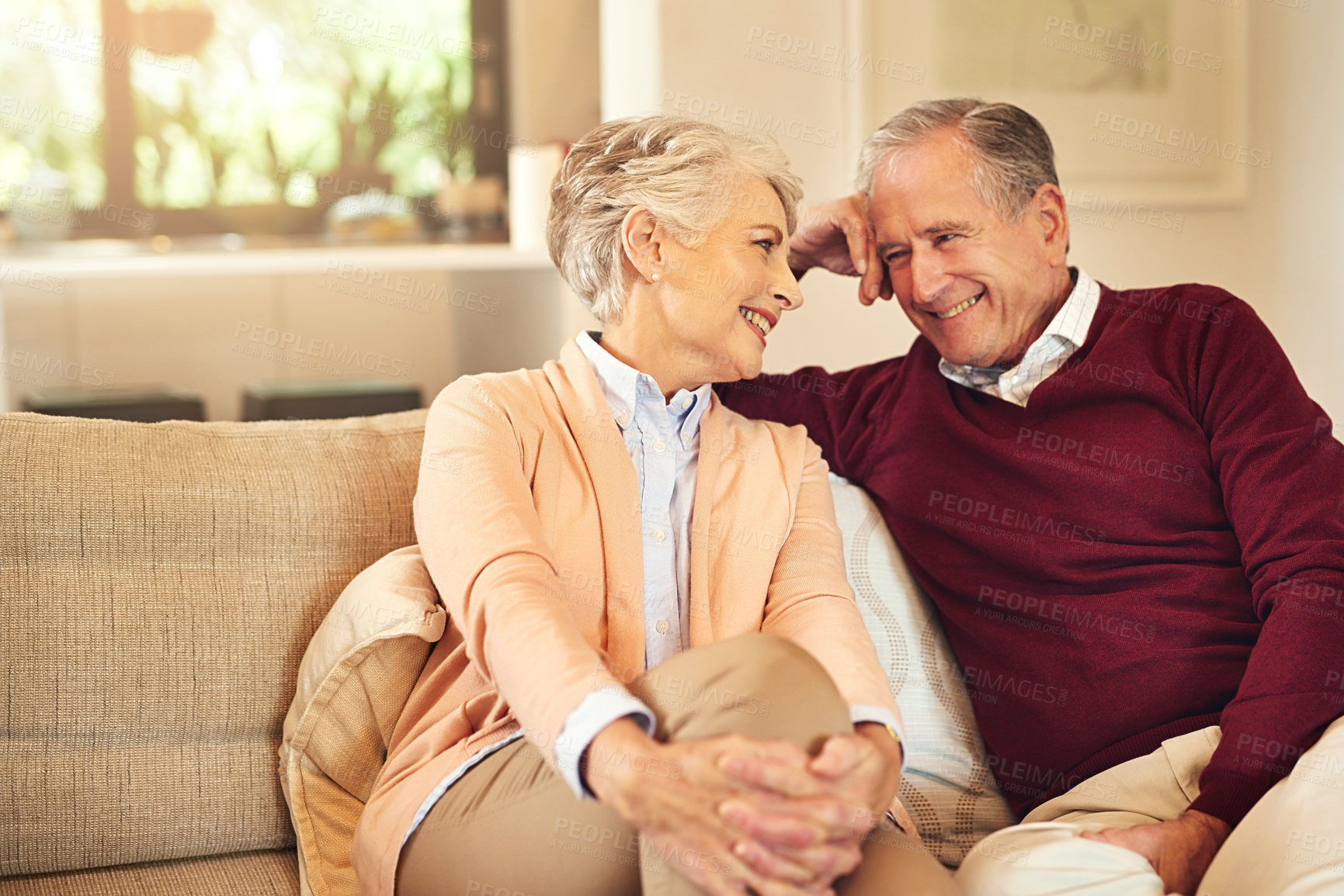 Buy stock photo Shot of a senior couple spending time together in the living room