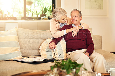 Buy stock photo Shot of a senior couple spending time together in the living room