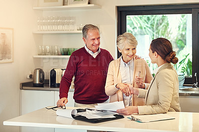 Buy stock photo Shot of a senior couple getting advice from their financial consultant