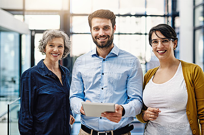 Buy stock photo Portrait of a group of creatives working together on a digital tablet in an office