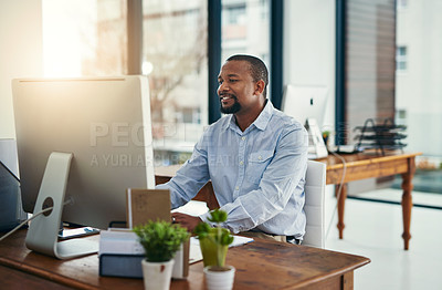 Buy stock photo Cropped shot of a businessman working on a computer in an office