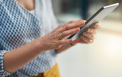 Buy stock photo Closeup shot of a businesswoman working on a digital tablet in an office