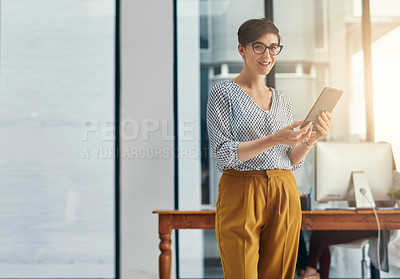 Buy stock photo Portrait of a young creative working on a digital tablet in an office