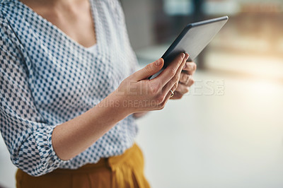 Buy stock photo Closeup shot of a businesswoman working on a digital tablet in an office