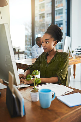 Buy stock photo Cropped shot of a businesswoman working on her computer in the office