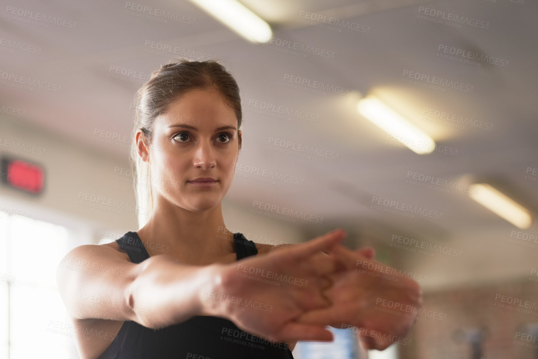 Buy stock photo Face, fitness and stretching with sports woman in gym for health, serious workout or strength. Exercise, mindset and warm up with athlete getting ready for training to improve physical condition