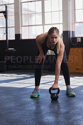 Buy stock photo Shot of a young woman doing weight lifting exercises at the gym