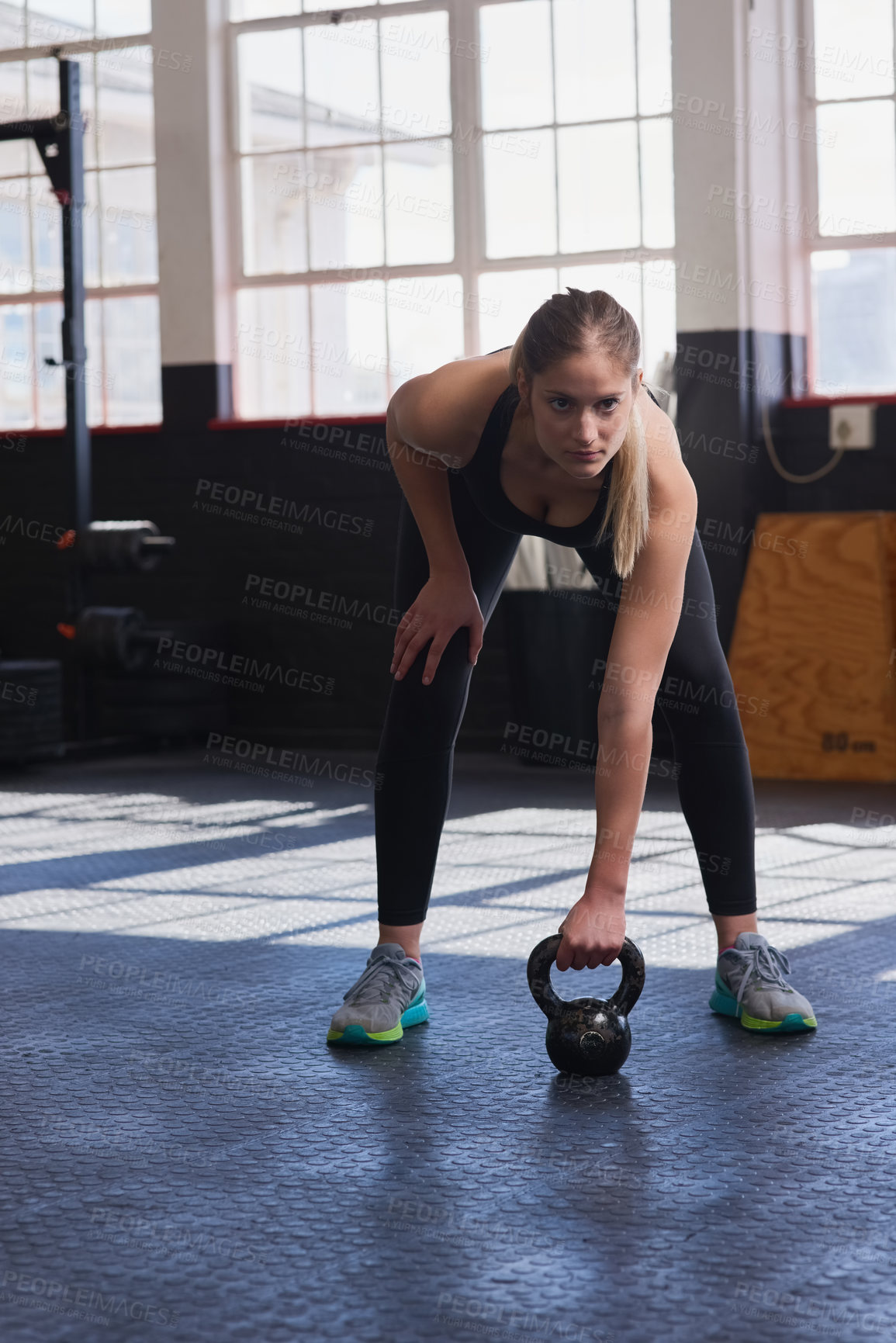 Buy stock photo Fitness, kettlebell and woman with motivation in gym for workout, training and strength for core muscle. Female athlete, physical activity or exercise with balance, endurance or commitment in sports
