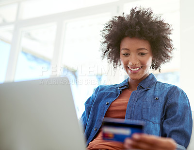 Buy stock photo Shot of an attractive young woman shopping online from the comfort of home