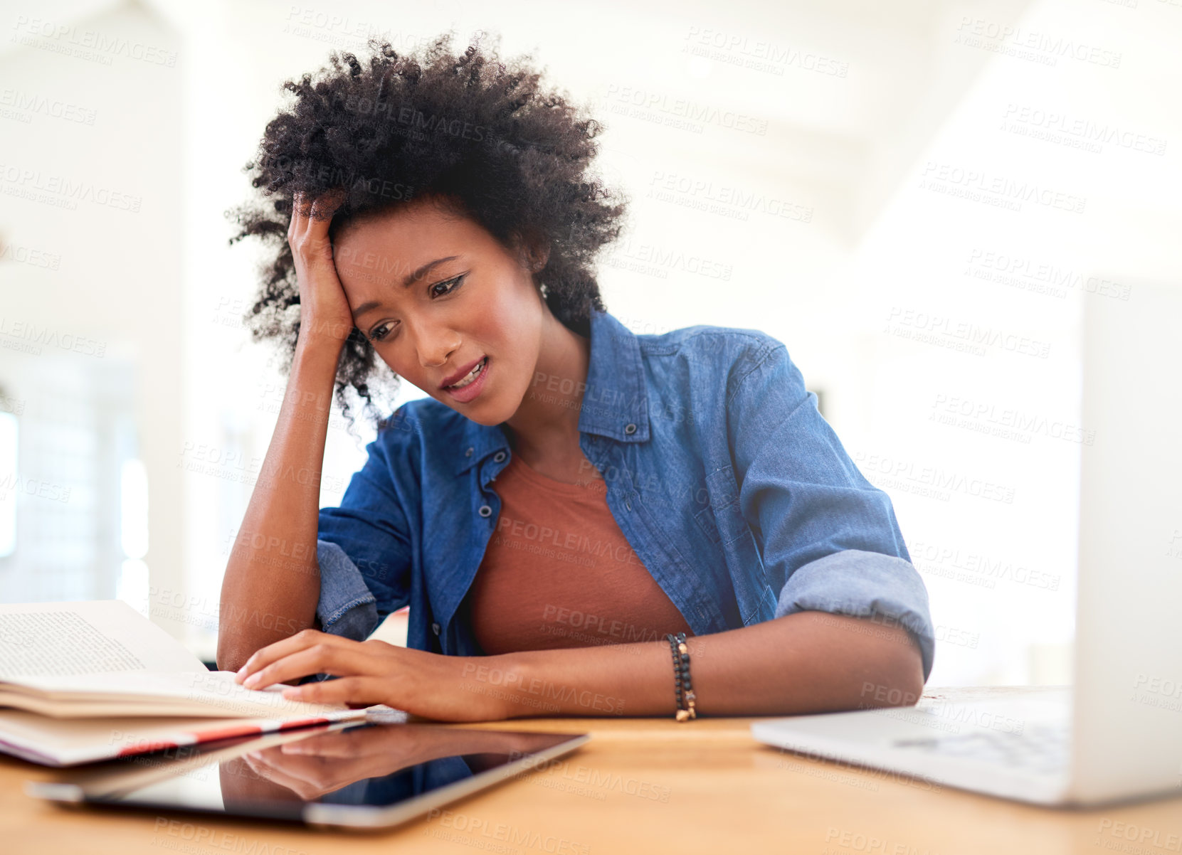 Buy stock photo Shot of an attractive young woman looking stressed while working from home