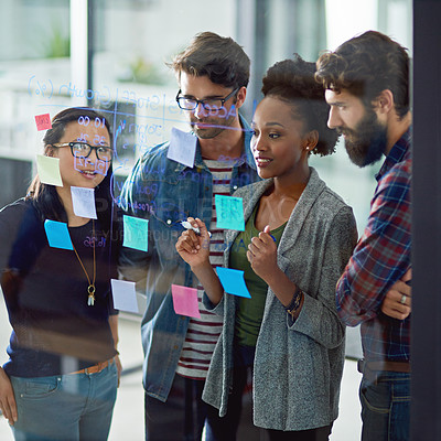 Buy stock photo Sticky notes, glass wall and business people with teamwork in office for planning or brainstorming. Collaboration, diversity and group of copywriters working on creative project with discussion.