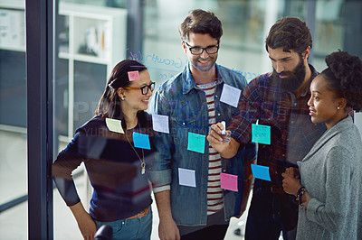 Buy stock photo Sticky notes, glass wall and business people in discussion with teamwork in office for planning or brainstorming. Collaboration, diversity and group of copywriters working on project in meeting.