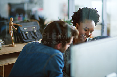 Buy stock photo Shot of two young businesspeople talking in the office