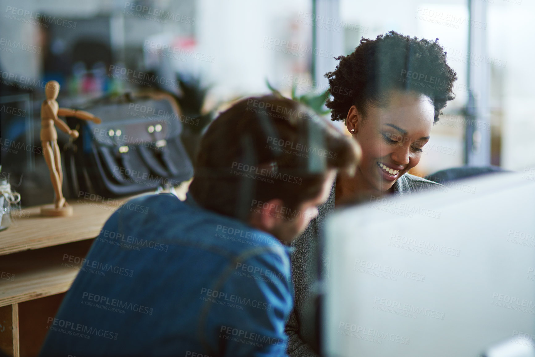 Buy stock photo Shot of two young businesspeople talking in the office