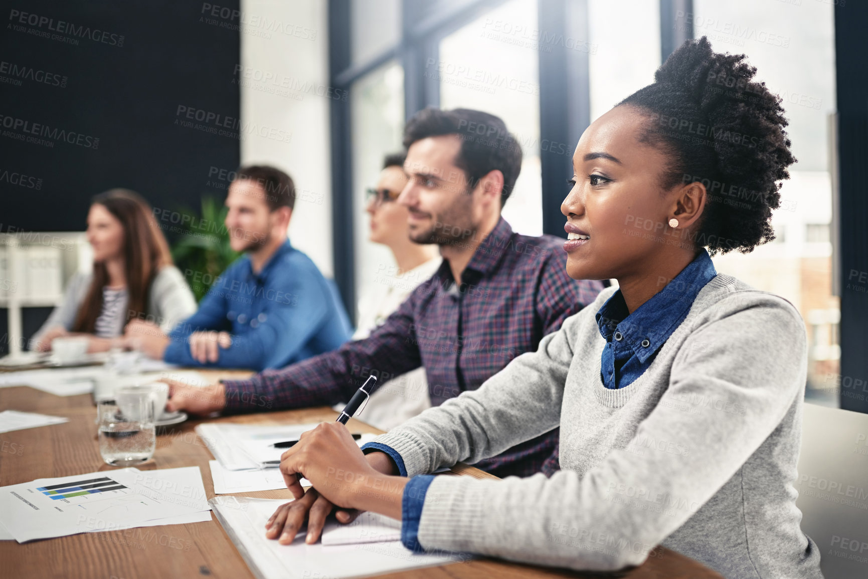 Buy stock photo Cropped shot of a group of businesspeople sitting in on a presentation