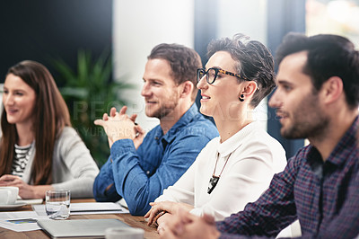 Buy stock photo Cropped shot of a group of businesspeople sitting in on a presentation