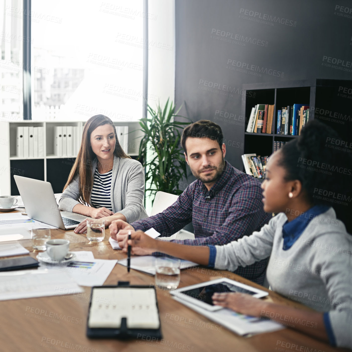 Buy stock photo Cropped shot of a group of businesspeople meeting in the boardroom