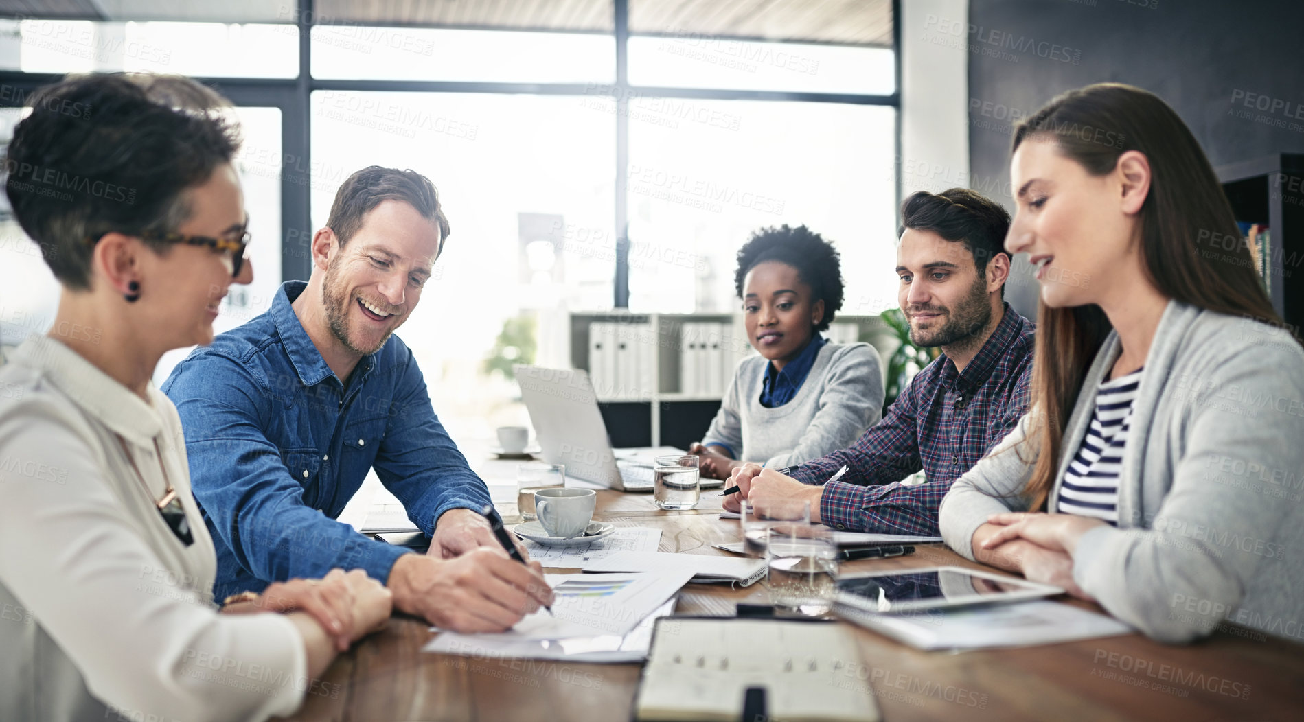 Buy stock photo Cropped shot of a group of businesspeople meeting in the boardroom