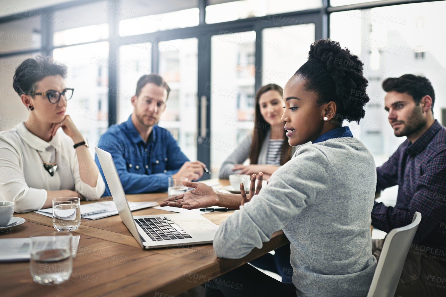 Buy stock photo Cropped shot of a group of businesspeople meeting in the boardroom