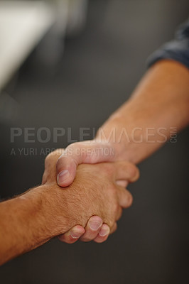 Buy stock photo Closeup shot of two businessmen shaking hands in an office