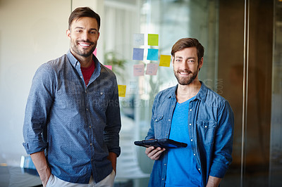 Buy stock photo Portrait of two young businessmen standing together in an office