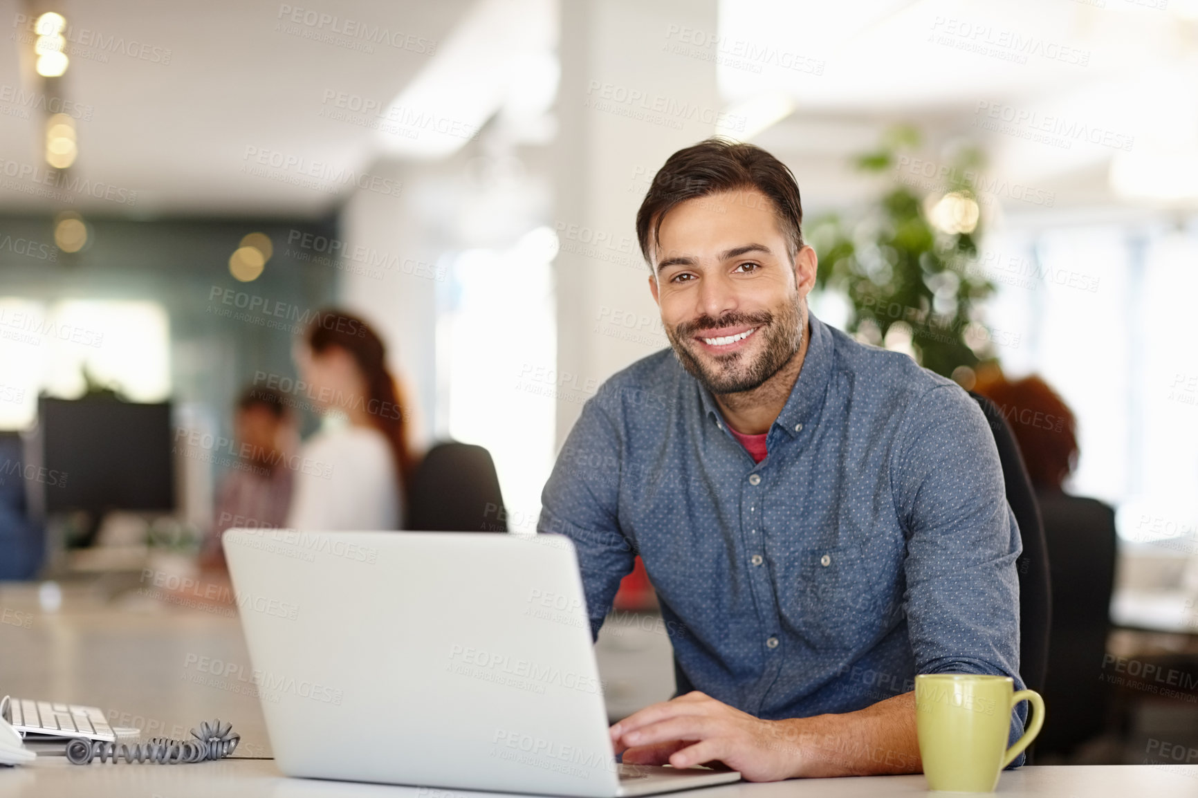 Buy stock photo Portrait of a confident young businessman sitting in an office